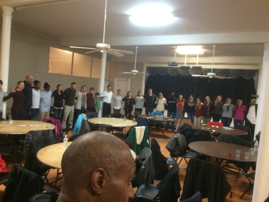 Back on My Feet DC members circle up to share what they are thankful for at a holiday potluck. 