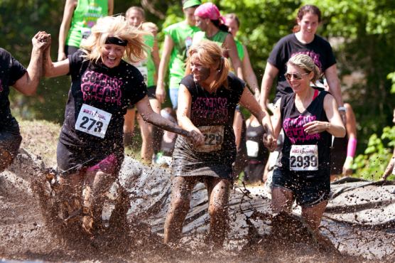 Several women run through the mud at a Dirty Girl Mud Run event near Atlanta, Ga., in 2012. (Photo © Russ Ensley | Dreamstime.com)