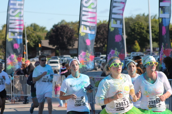 Runners cross the finish line at a Run or Dye race in Green Bay, Wis., in September 2013. The series received an "F" rating from the Salt Lake City Better Business Bureau. (Photo © Wayne Gauger | Dreamstime.com)