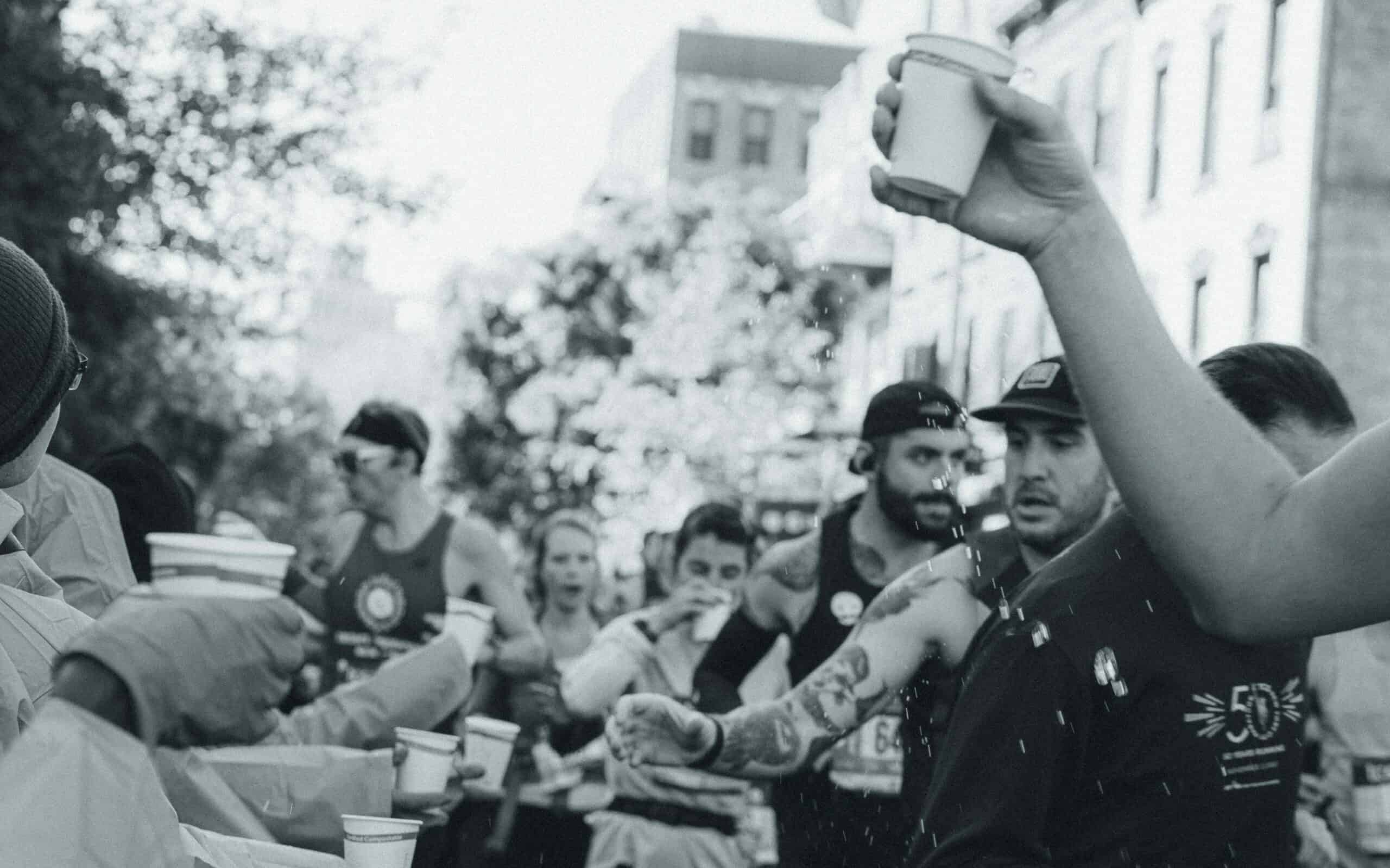 Do I need to fuel during a half marathon? Runners taking their water on course.