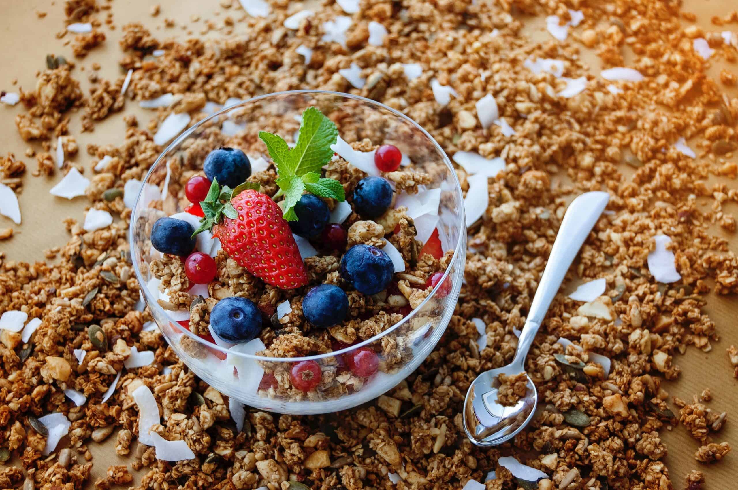 Yogurt with granola, coconut, mint, blueberries and cranberries making a high protein snacks for runners.