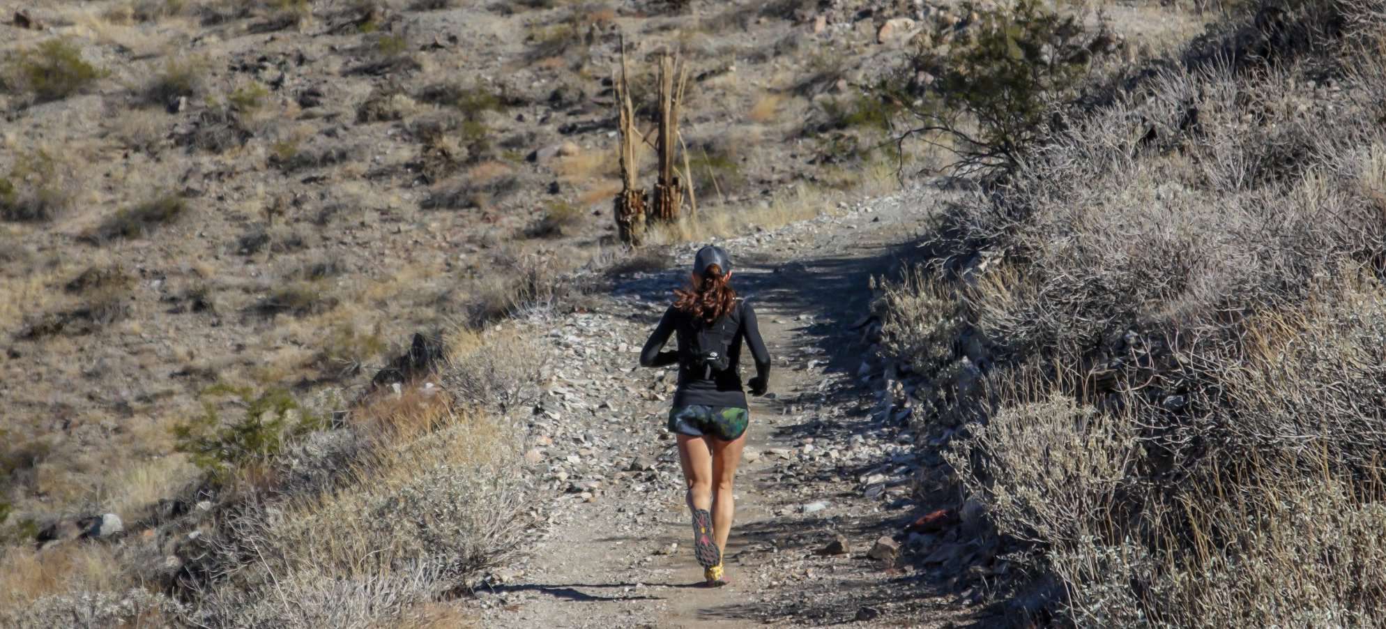 A runner in the course of XTERRA Estrella Mountain Trail Run Marathon, Half Marathon, 12k, & 5k in Goodyear, AZ