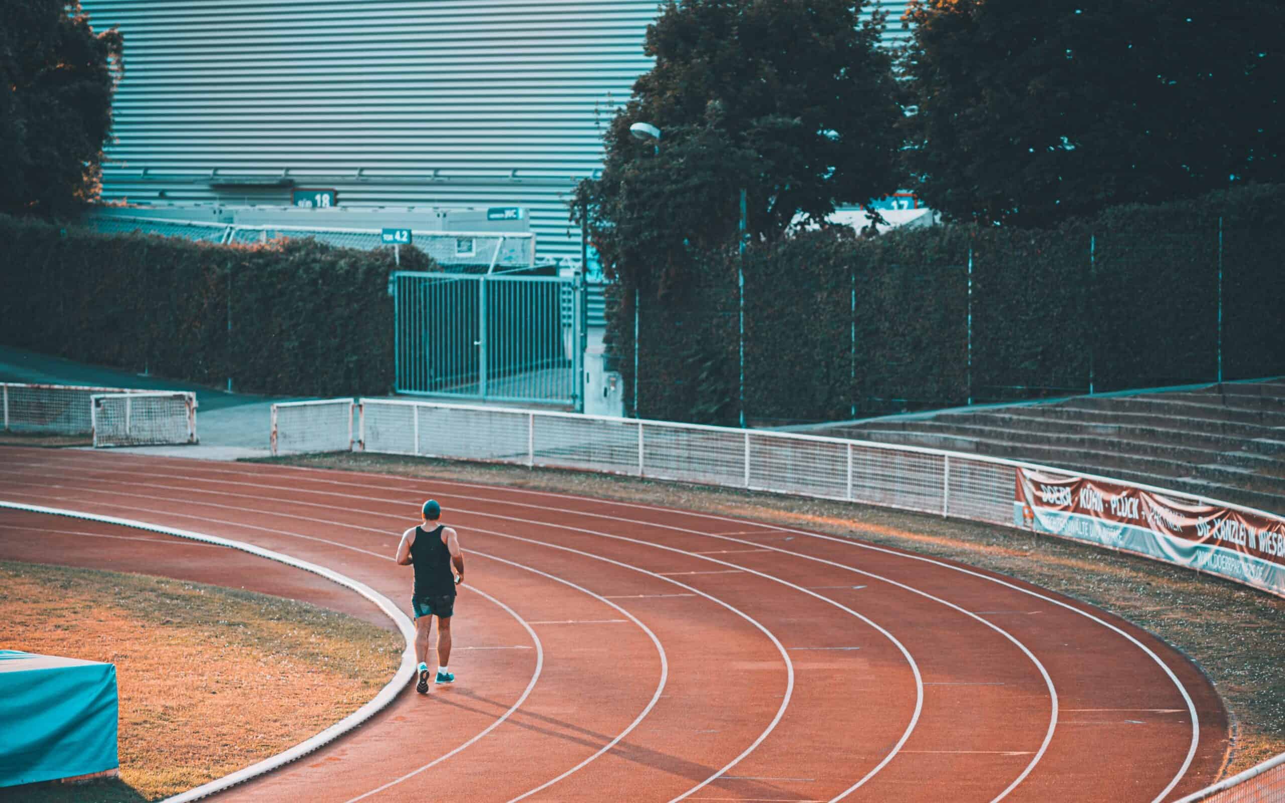 A male running on a track one of the most common types of running for speed workouts.