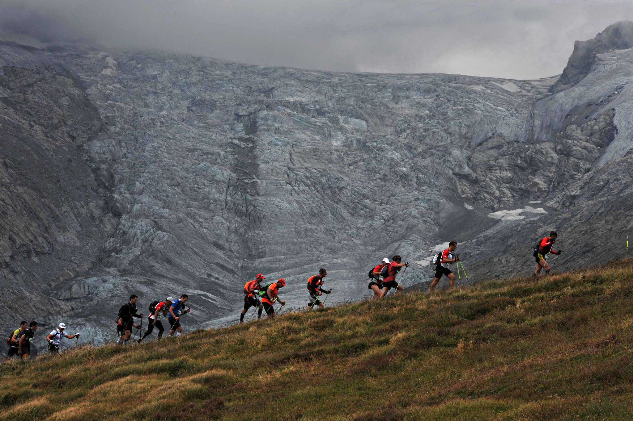Runners along the Ultra Tour du Mont Blanc trail at high altitude.