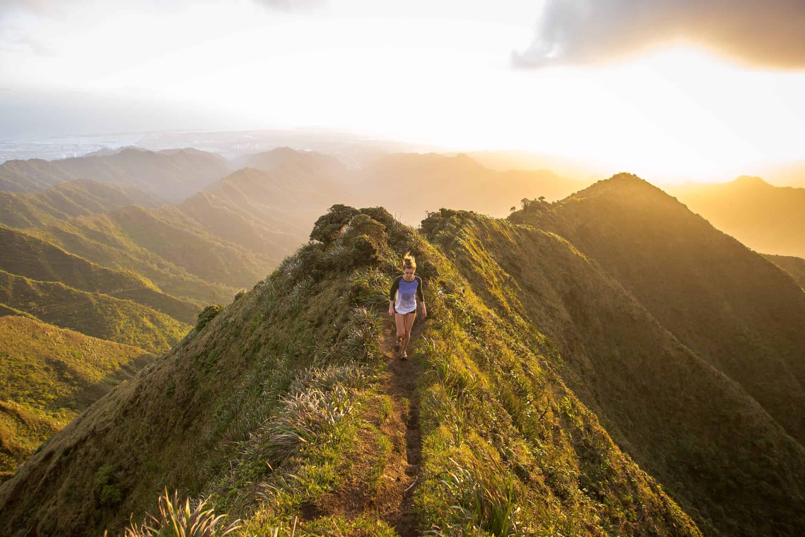Woman running on trail at high altitude.