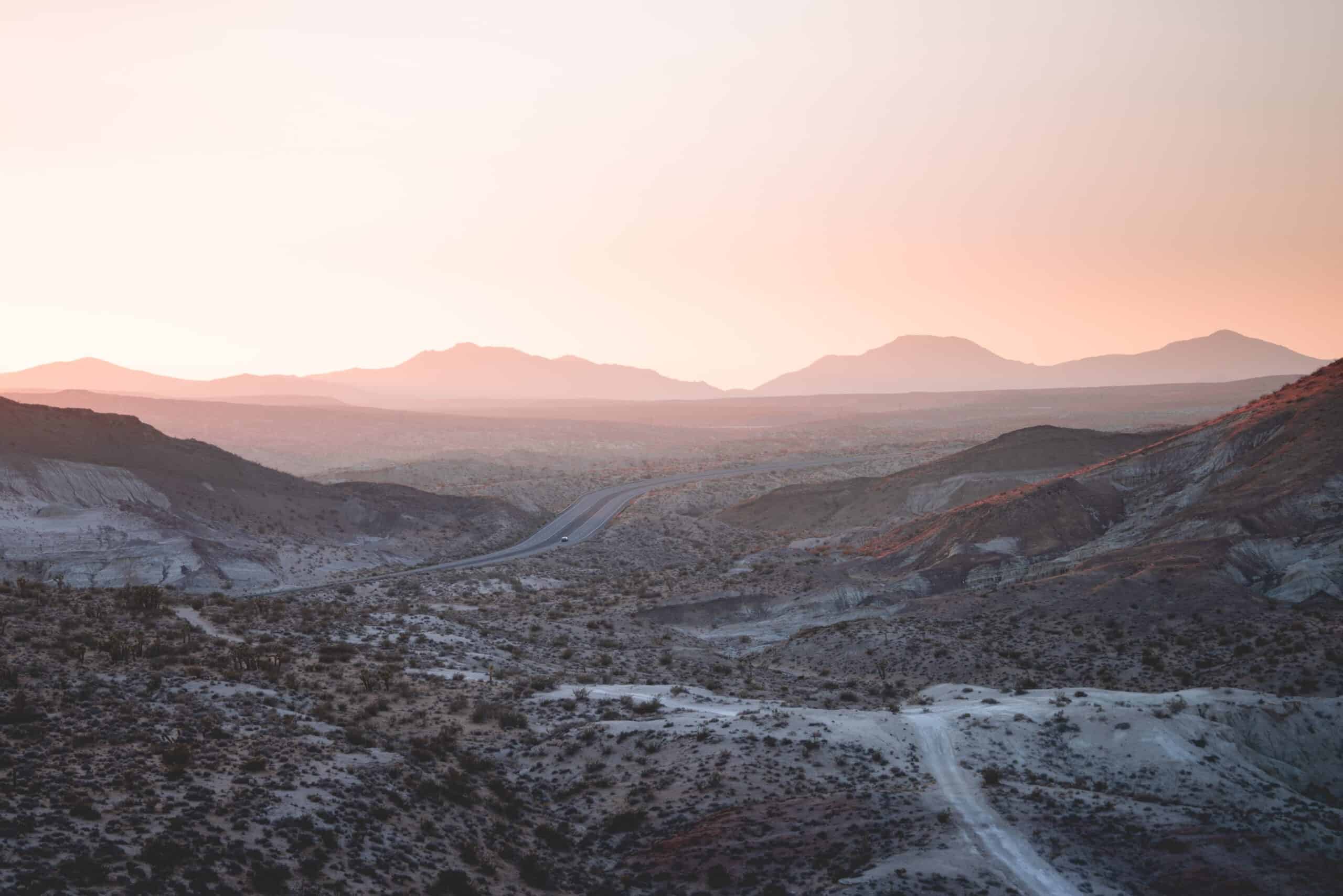 Red Rock Canyon in Nevada with a single road at sunset.