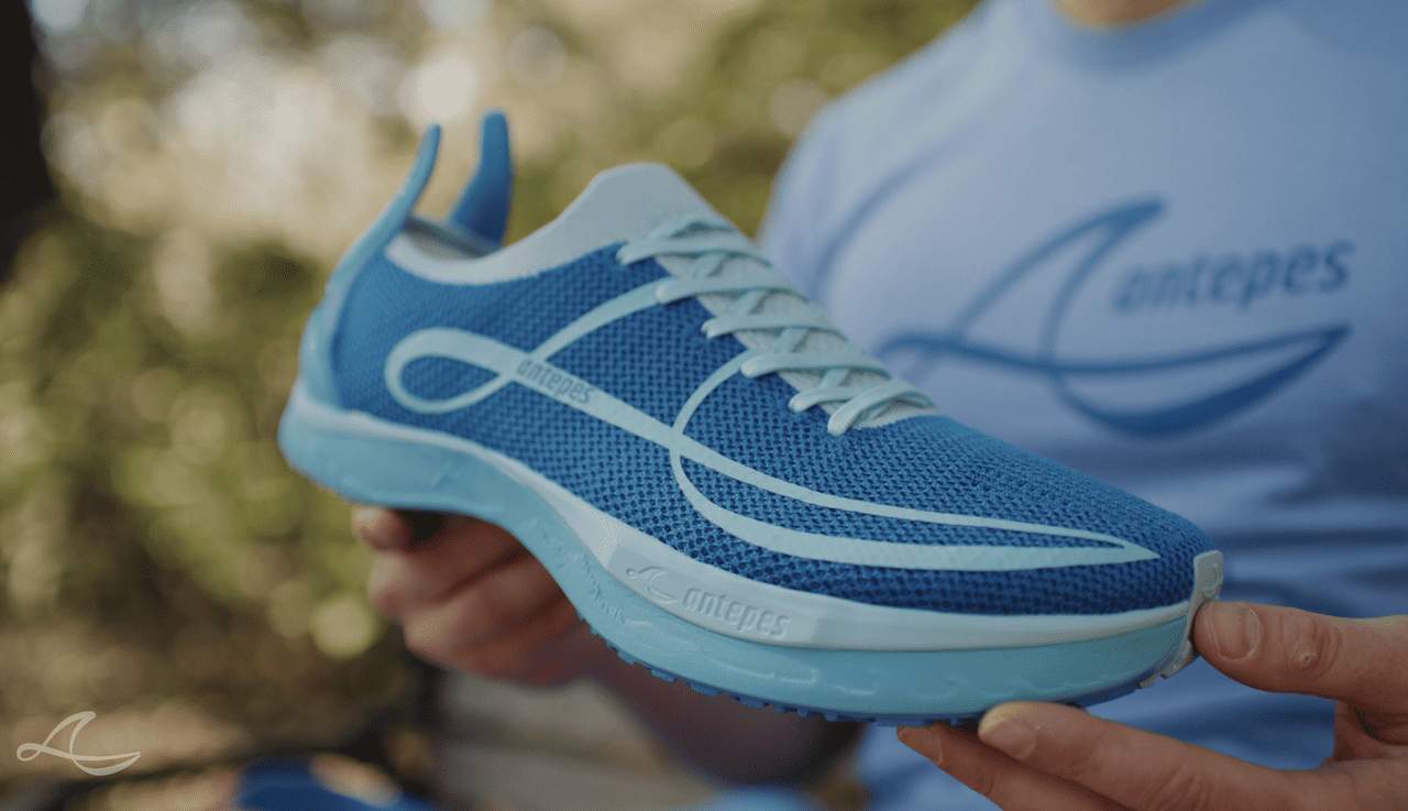 Antepes Muscle Runner shoe being held by a man.