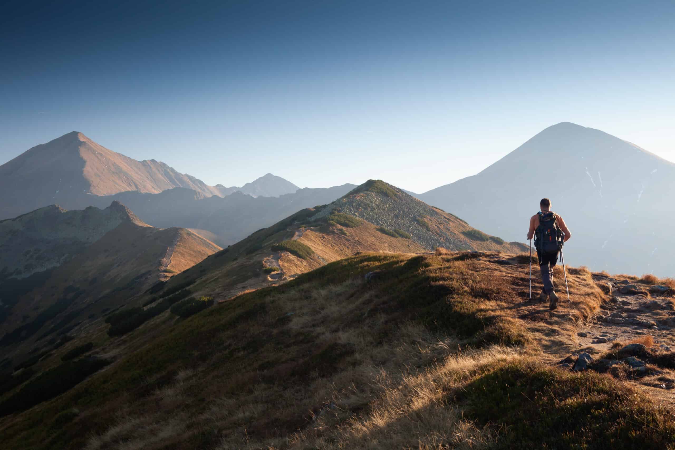Backpacker at Ornak Peak in Tatra Mountains, Poland to illustrate how rucking vs. running might be similar.