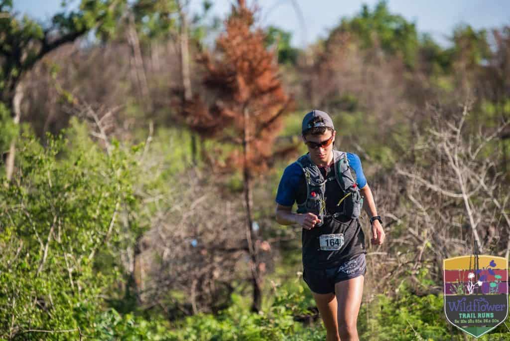 A runner in the trail course of Wildflower Trail Run
