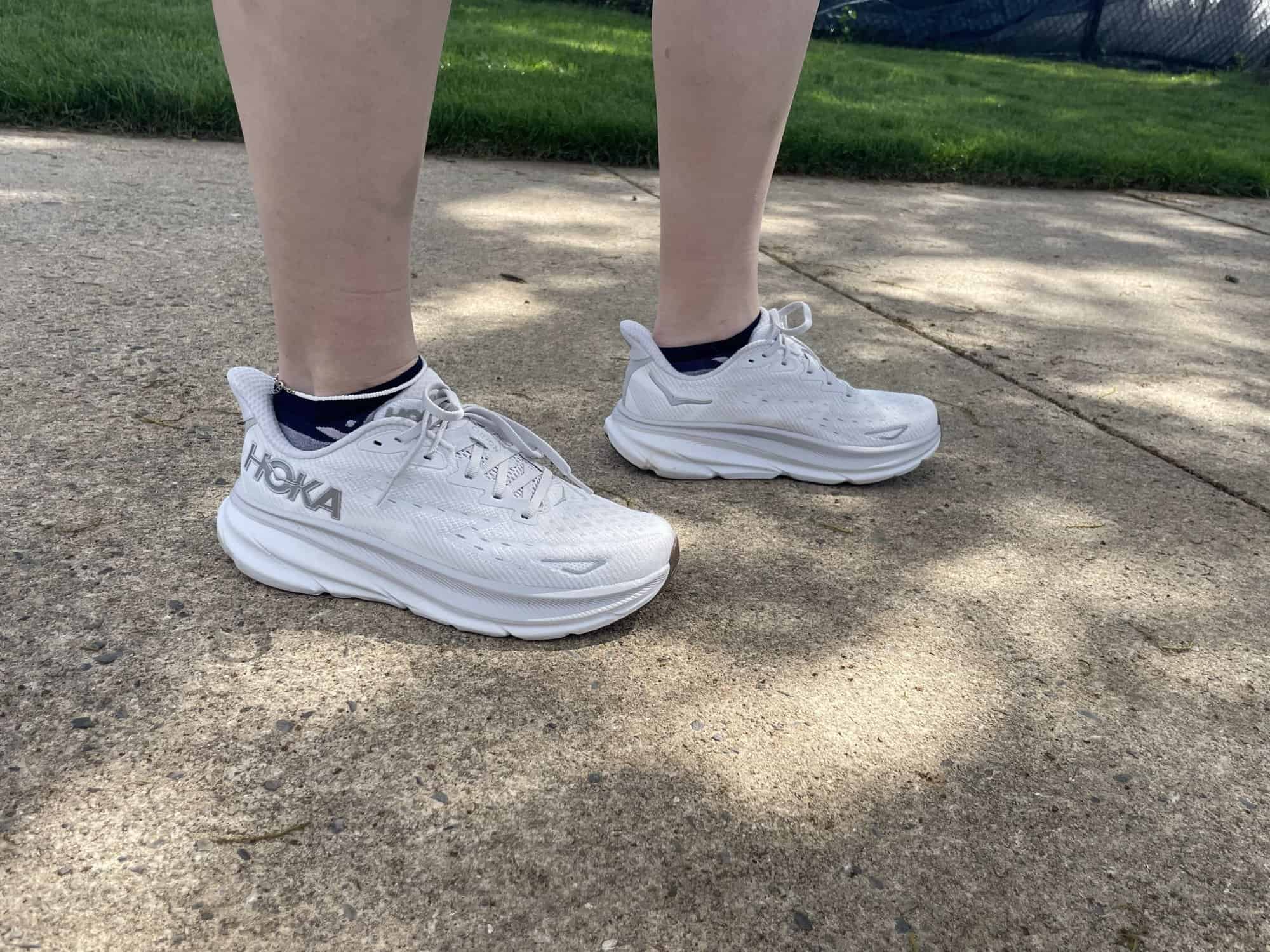 Writer Gabrielle Hondorp standing in the Hoka Clifton 9 running shoes during testing.