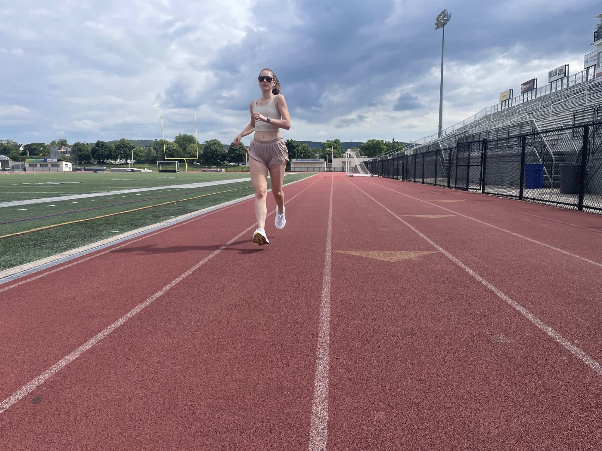Writer Gabi Horndorp testing the Saucony Hurricane 24 on a high school track, running toward the camera
