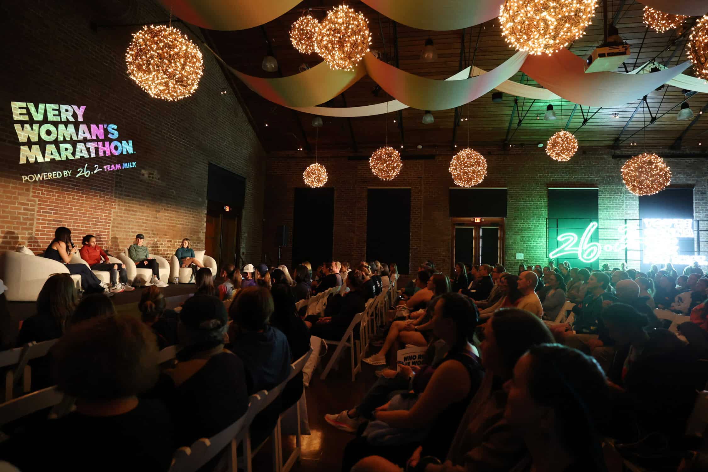 Four women runners speaking on a panel at Every Women's Marathon fair & expo