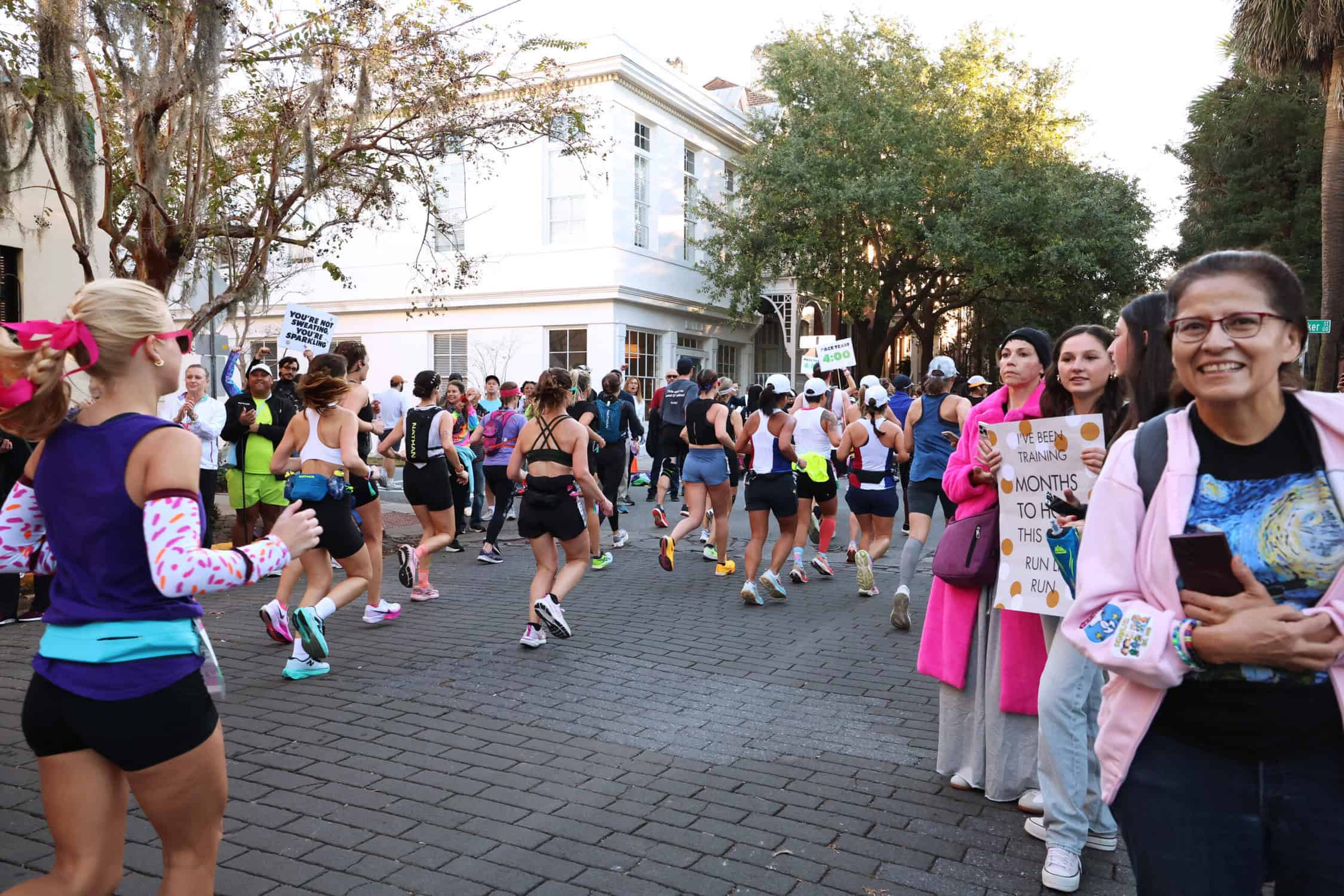 women runners on cobblestone streets running the every woman's marathon