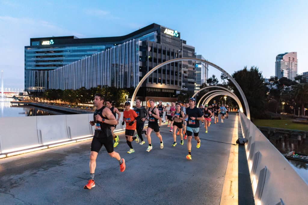 runners across a bridge in the Run Melbourne Half Marathon